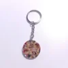 KEYCHAIN-0007 (1) Μπρελόκ στρογγυλό με πέταλα λουλουδιών & φύλλα χρυσού