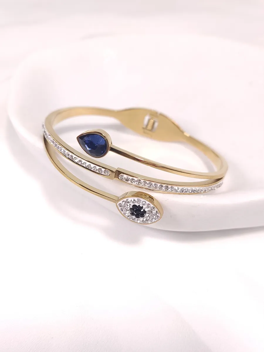 Βραχιόλι χειροπέδα ατσάλινη χρυσή με ματάκι και μπλε στοιχείο